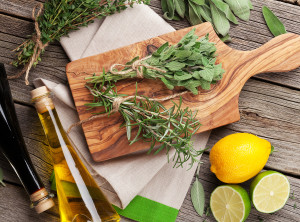 Fresh garden herbs and condiments on wooden table. Oregano, thym
