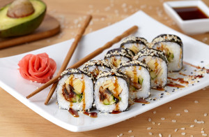Futomaki sushi roll with eel, cucumber, sesame seeds, ginger, an