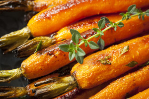 Roasted baby carrots garnished with thyme.