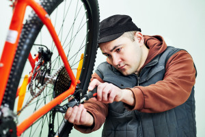 Bike maintenance. mechanic serviceman repairman installing assem