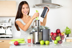Vegetable juice raw food - healthy eating woman with juicer juic