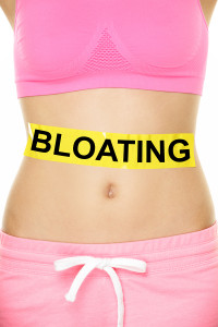 Bloating in stomach abdomen. BLOATING text written on female sto