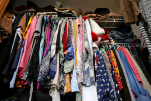 Messy Women's Closet Filled With Colorful Clothes