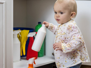 Little Girl Playing With Household Cleaners