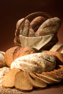Assortment Of Baked Bread Over Brown Background